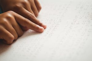 Child using braille to read at school