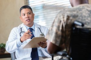 Medical doctor evaluates veteran during appointment